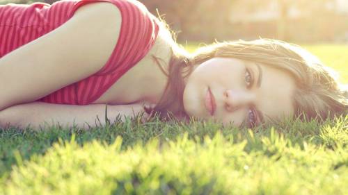 Beautiful Girl Lying In The Grass